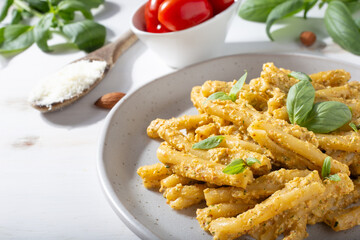 Sicilian pasta with almond and tomatoes pesto. Typical Italian food from Sicily. Food suitable for vegetarians.