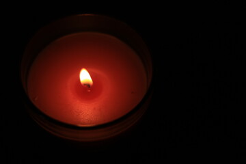 one candle in a dark place for festivals or religions