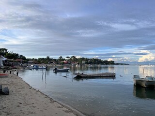 Fototapeta premium Low tide clear waters with fishermen boats during dusk at Cap Ferret, Arcachon Bay in Summer