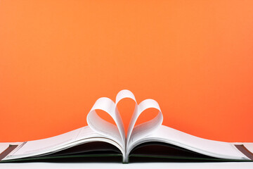 Old open hardback book, page decorate into a flower shape for love in Valentine's. love with open book heart.