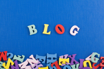 BLOG word on blue background composed from colorful abc alphabet block wooden letters, copy space...
