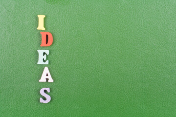 IDEAS word on green background composed from colorful abc alphabet block wooden letters, copy space...