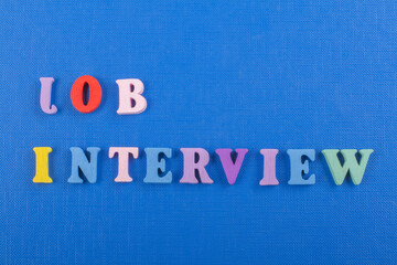 JOP INTERVIEW word on blue background composed from colorful abc alphabet block wooden letters,...