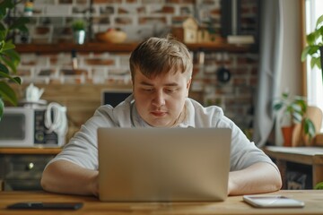 Young man with down syndrome learning online at home