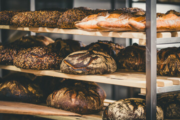 Freshly baked bread in a shelf cart in a bakery