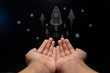 Hands with a rocket and arrow up. Business development, financial plan and strategy concept.