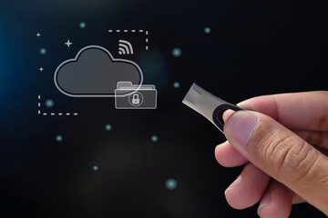 Hand holding a USB flash drive. Cloud computing and backup storage technology concept.