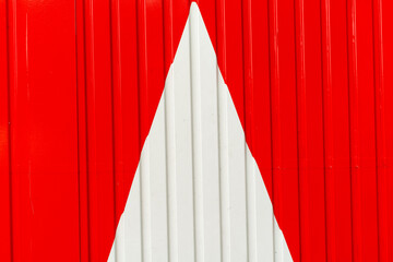 Metal wall, white arrow on red background