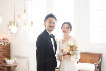 Image of bride and groom gazing at each other at wedding ceremony with beautiful semi-backlit...