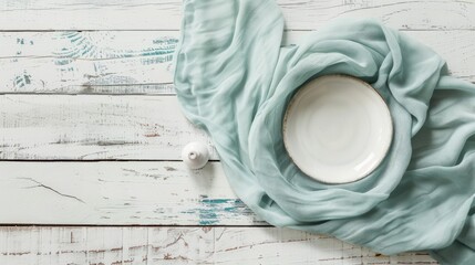 Light blue green linen on rustic white wood surface.