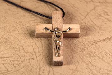 Small wooden crucifix on a cord. Neck cross with Jesus Christ