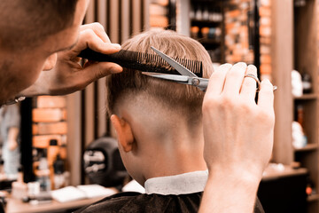 Concept Barbershop for man. Closeup master hairdresser does hairstyle and style with scissors and...