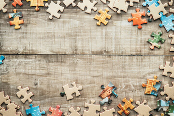 Colorful puzzle pieces on a wooden background. - Powered by Adobe