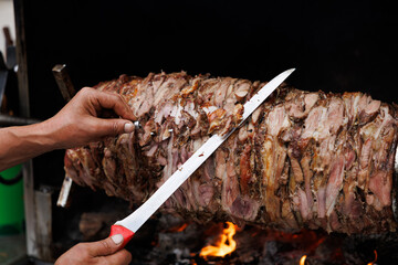 Authentic Cağ Kebab Being Sliced Over Open Flame by Chef