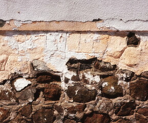 Close-Up Peeling White Paint On Aged Stone Wall