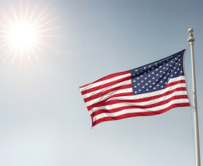 Obraz premium A large American flag waving in the wind against a bright, cloudy sky