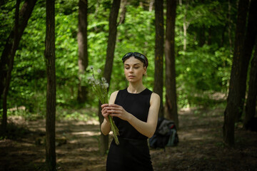 Girl Walking Through Forest Holding Dandelions