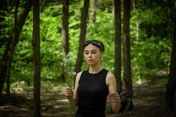 Girl Walking Through Forest Holding Dandelions