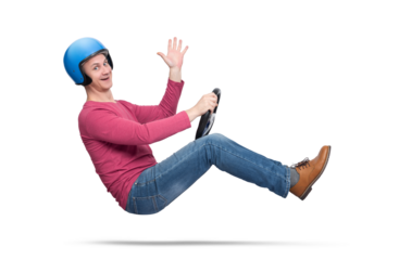 A happy young man in a motorcycle helmet drives a car and sends greetings to the camera, isolated on a transparent background png