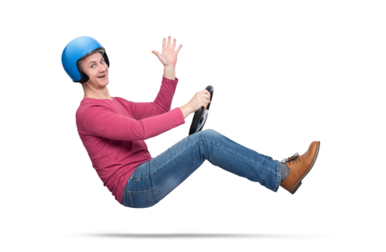 A happy young man in a motorcycle helmet drives a car and sends greetings to the camera, isolated on a transparent background png