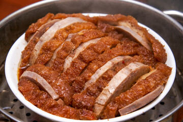 A bowl of fragrant and delicious traditional Chinese dishes, taro braised pork