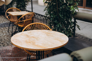 Outdoor street cafe tables ready for service. Modern Empty cafe terrace with table and chair,...