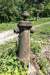 An old, corroding, non-functioning hydrant, a reminder of communist times