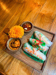 Spring roll at wooden plate.