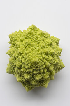 Top view of a whole head of Romanesco cauliflower (also known as broccolo romanesco, romanesco broccoli, romanesque cauliflower) without leaves isolated on a white background.