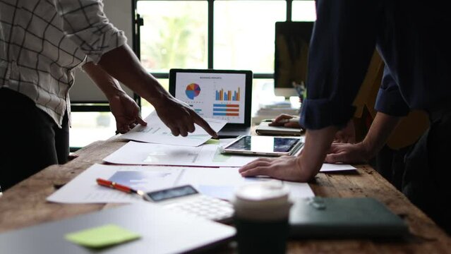 Financial advisor meeting is discussing analysis of business growth chart and market situation and financial planning.