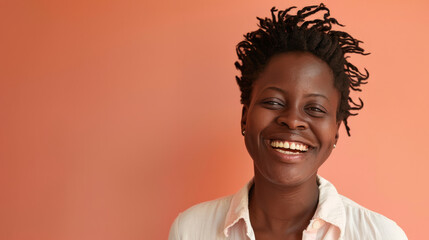A woman with dreadlocks is smiling and looking at the camera