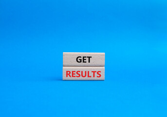 Get results symbol. Wooden blocks with words Get results. Beautiful blue background. Business and...