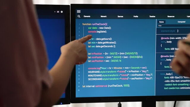 Slow motion back end software developer engineer for computer programming working together on debugging writing computing code, solving complex algorithms display on monitor in office. Burgeoning