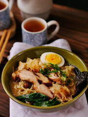 Toripaitan ramen in a bowl, with egg, vegetable, grilled chicken and nori