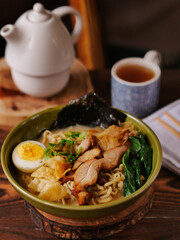 Toripaitan ramen in a bowl, with egg, vegetable, grilled chicken and nori