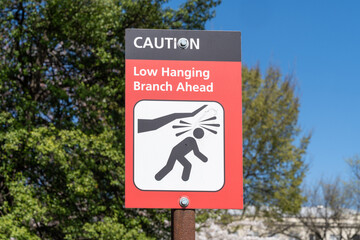 Sign at the Tidal Basin in Washington DC reminding of the low hanging branch ahead