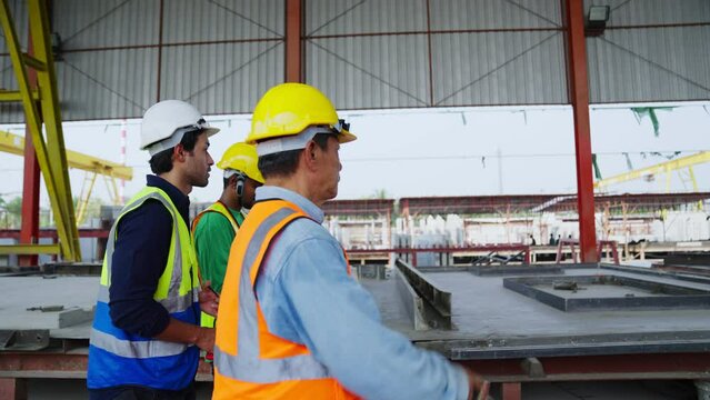 Team contractor or builder walking examining and checking project development house. Group of machine technicians architect or engineer inspection and planning construction site, industry concept.
