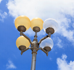 Modern round street lamps against blue sky