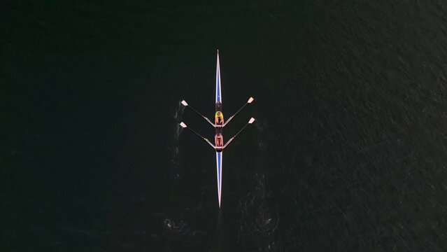 Top view of a two-seater sport canoe driven by two women Halifax. Canada. Their movements are fluid and purposeful, each stroke cutting through the water with precision.