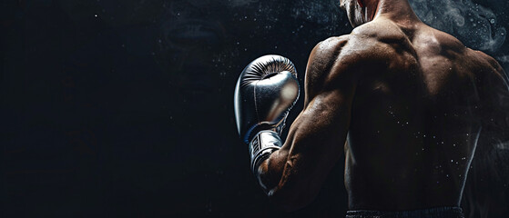 Boxer with Silver Boxing Gloves, Profile View Against a Dark Background
