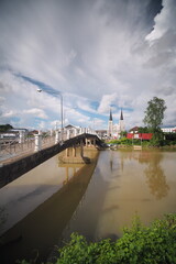 Obraz premium River View with ancient church, the Baptist tower over the city skyline and Reflective Waters.