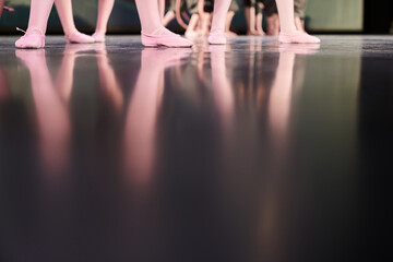 The reflection of children's feet on the stage. Classic children's choreography with the possibility of copying. There is a group of children on the stage, a lot of legs. High quality photo