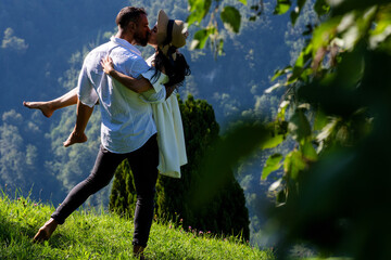 Young loving couple embracing on nature. Romantic kiss. Couple kiss on nature. Kissing couples....