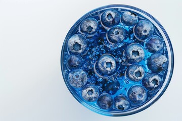 A refreshing blueberry cocktail in a glass against a white background