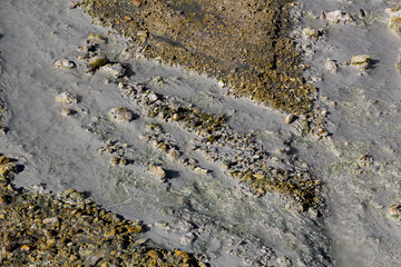 a close up to the volcanic thermal rocks and stones on the ground of Bumpass hell in lassen volcanic national park, califronia
