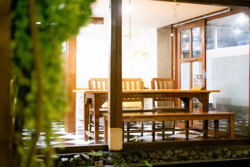 Selective Focus and blur on Climbing Plants and Wooden Cafe Table Set as Commercial Background