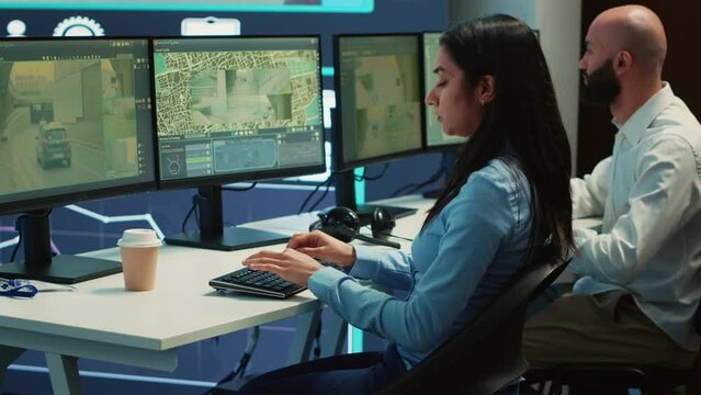 Indian shipping agency employee gathering data on traffic via surveillance footage, helping delivery trucks with cargo for shipment. Operator uses gps coordinates for tracking orders. Camera A.