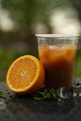 Non-alcoholic citrus cocktail in a plastic glass