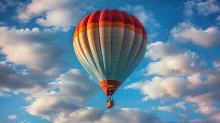 Stunning view of a vibrant hot air balloon ascending with a clear blue sky and fluffy clouds as backdrop