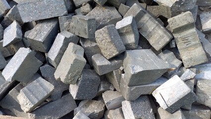 Pile of fragments of gray bricks or paving slabs 